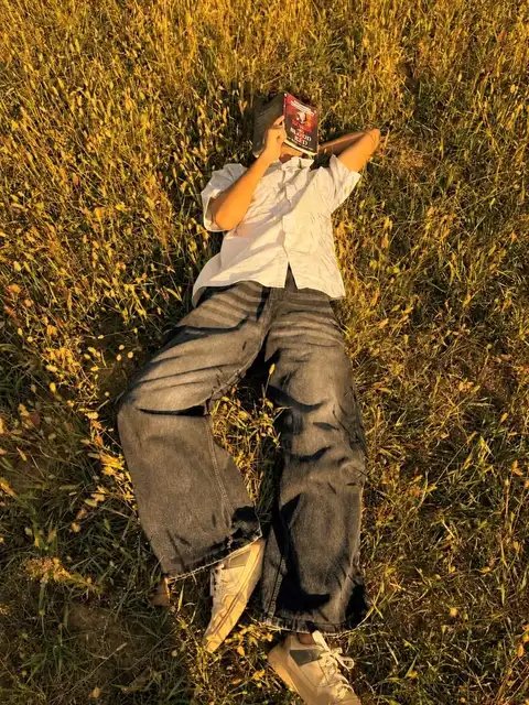A person standing in a field of tall grass.