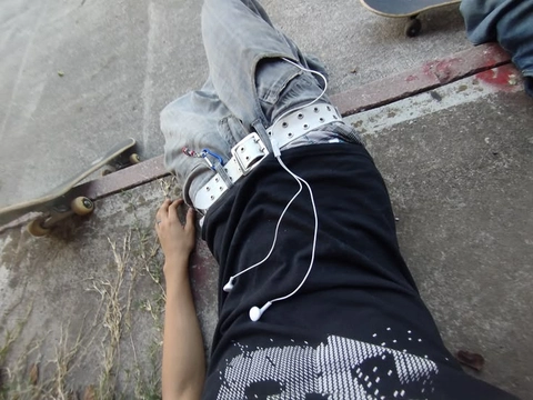 A person wearing roller skates on a sidewalk.