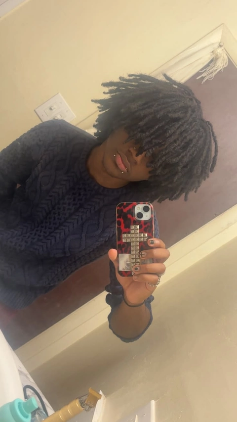 A woman taking a selfie in front of a mirror.