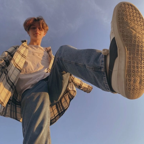 A man sitting on top of a pair of shoes.