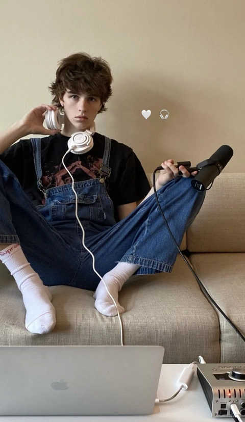 A man sitting on a couch with headphones on.