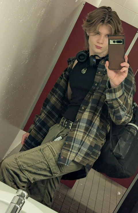 A woman taking a picture of herself in a mirror.