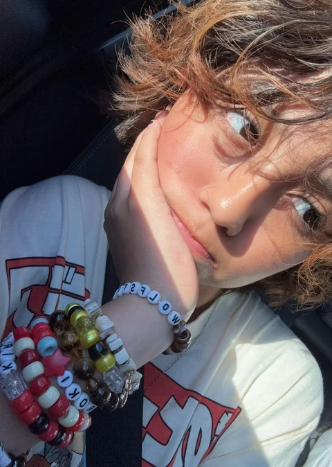 A close up of a person with a bracelet on their wrist.