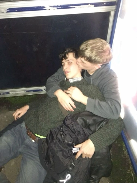 A group of young people sitting on top of a bus.