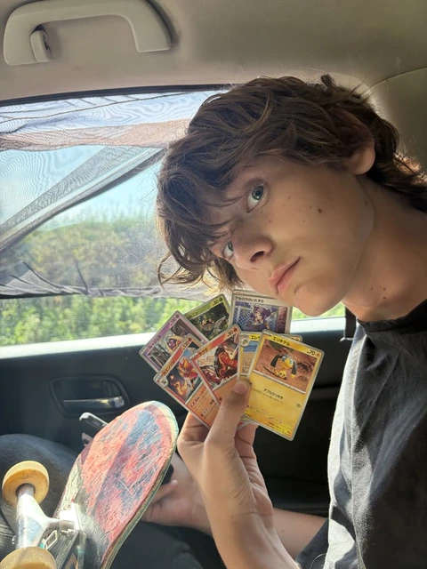 A woman holding a bunch of cards in her hands.