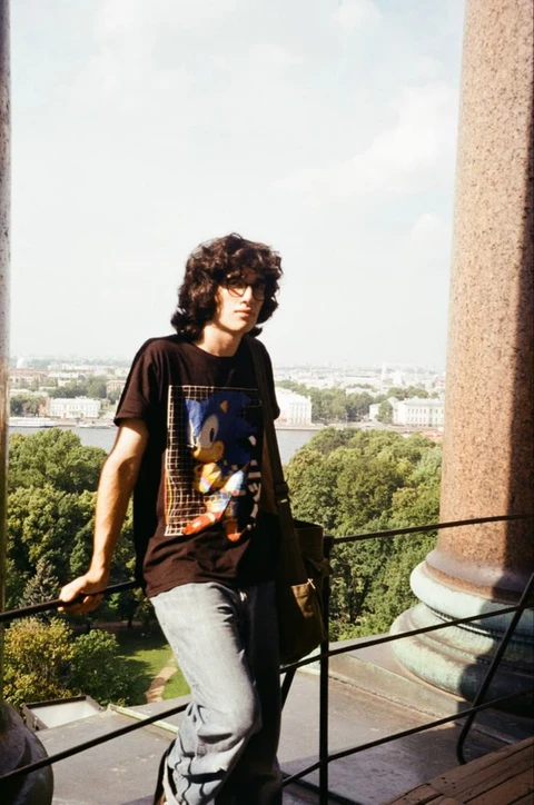 A man standing on top of a metal railing.