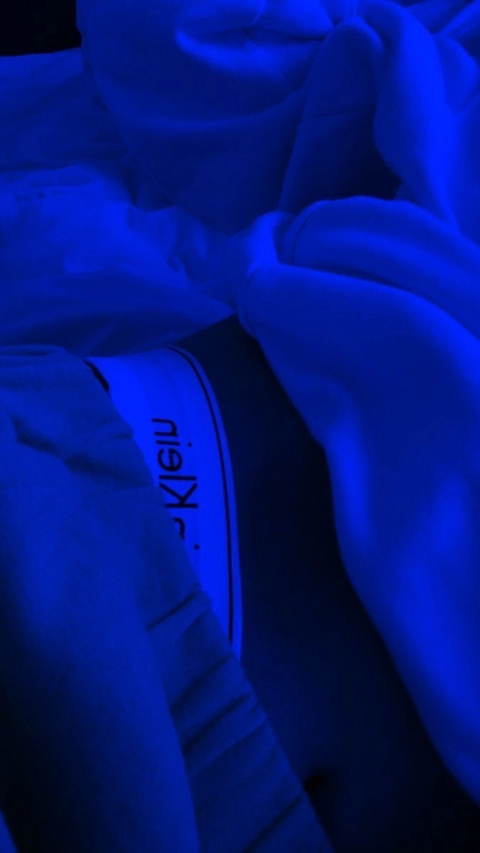 A close up of a person's hands in the dark.