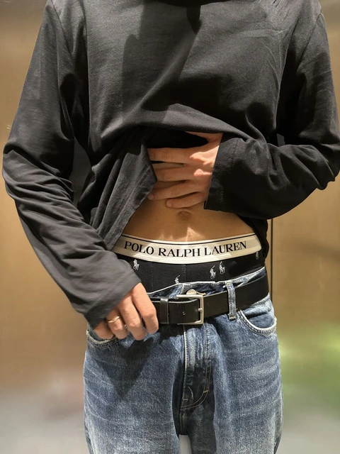 A mannequin wearing a black shirt and jeans.