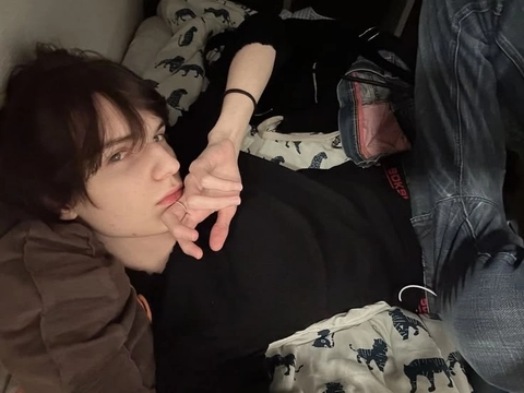 A man laying on top of a bed next to a woman.