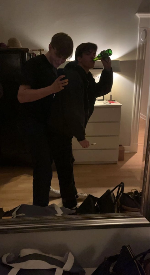 A group of people standing in front of a mirror.