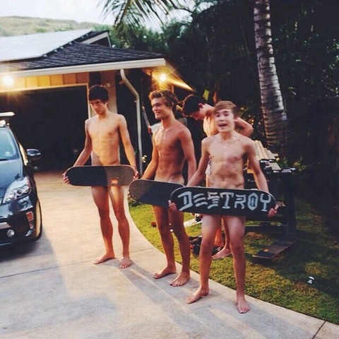 A group of naked men standing next to each other holding skateboards.
