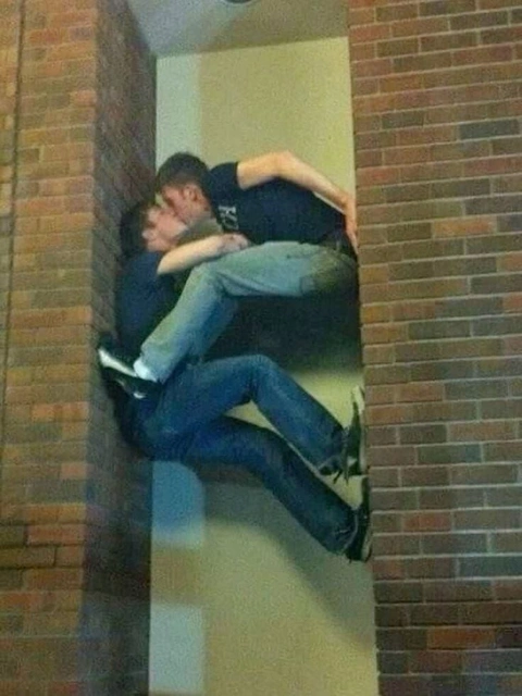 A couple of people that are standing in a building.