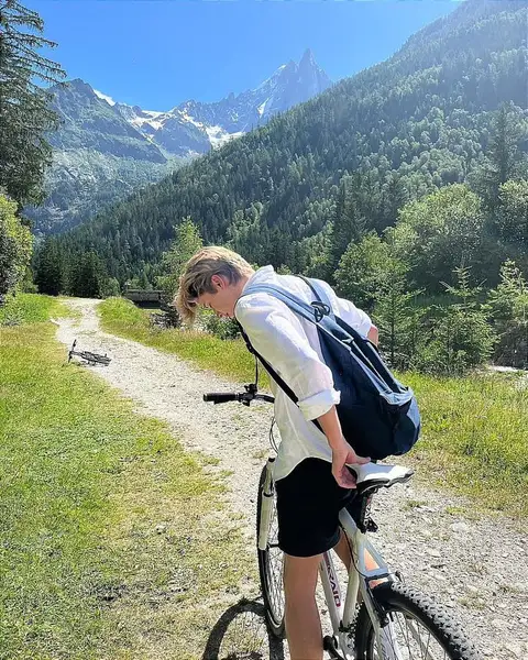 A man riding a bike down a dirt road.